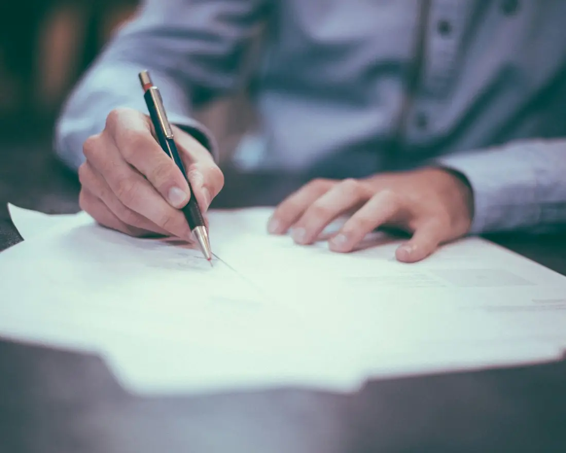 Business owner reviewing and signing business loan paperwork